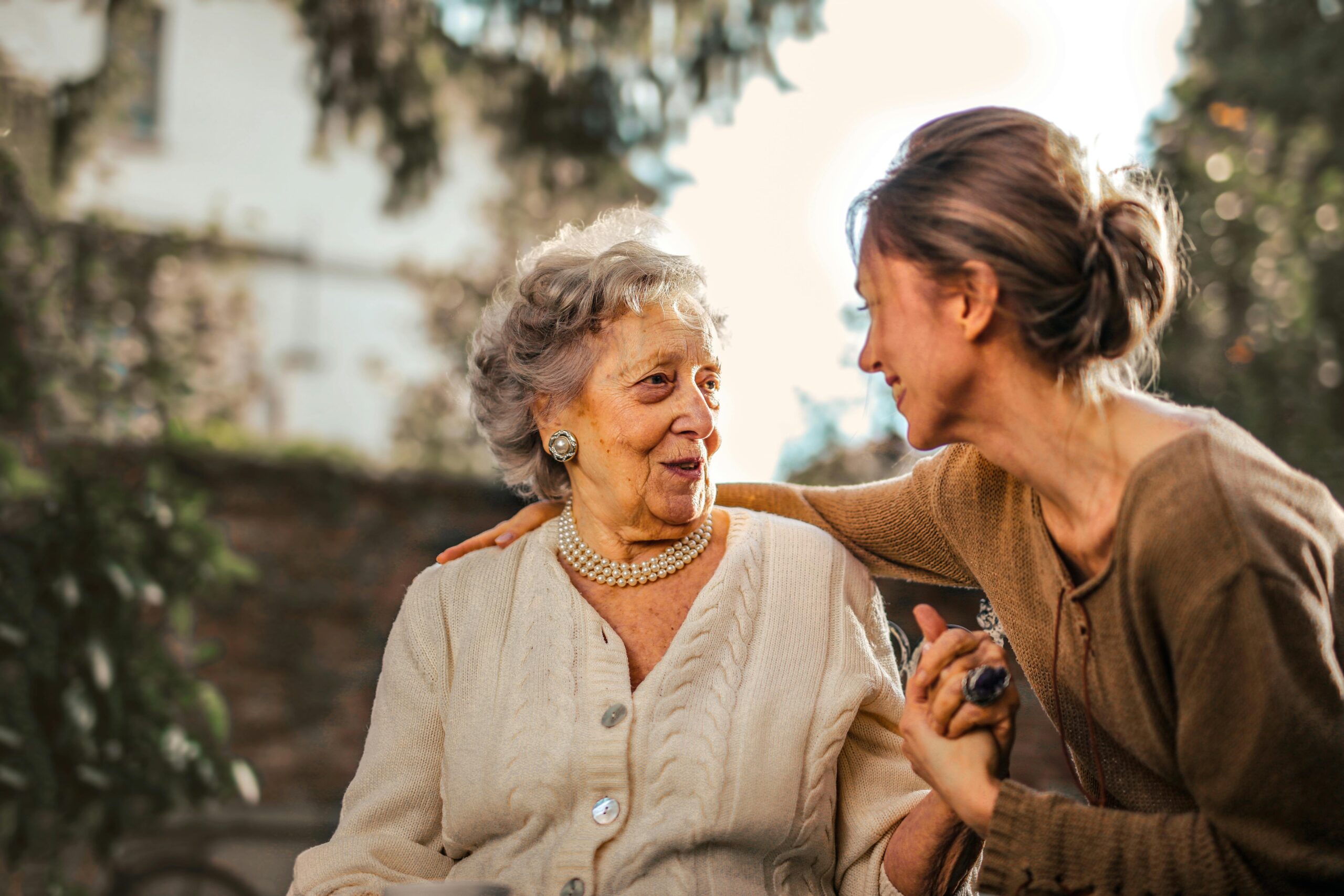 Two ladies laughing and chatting together