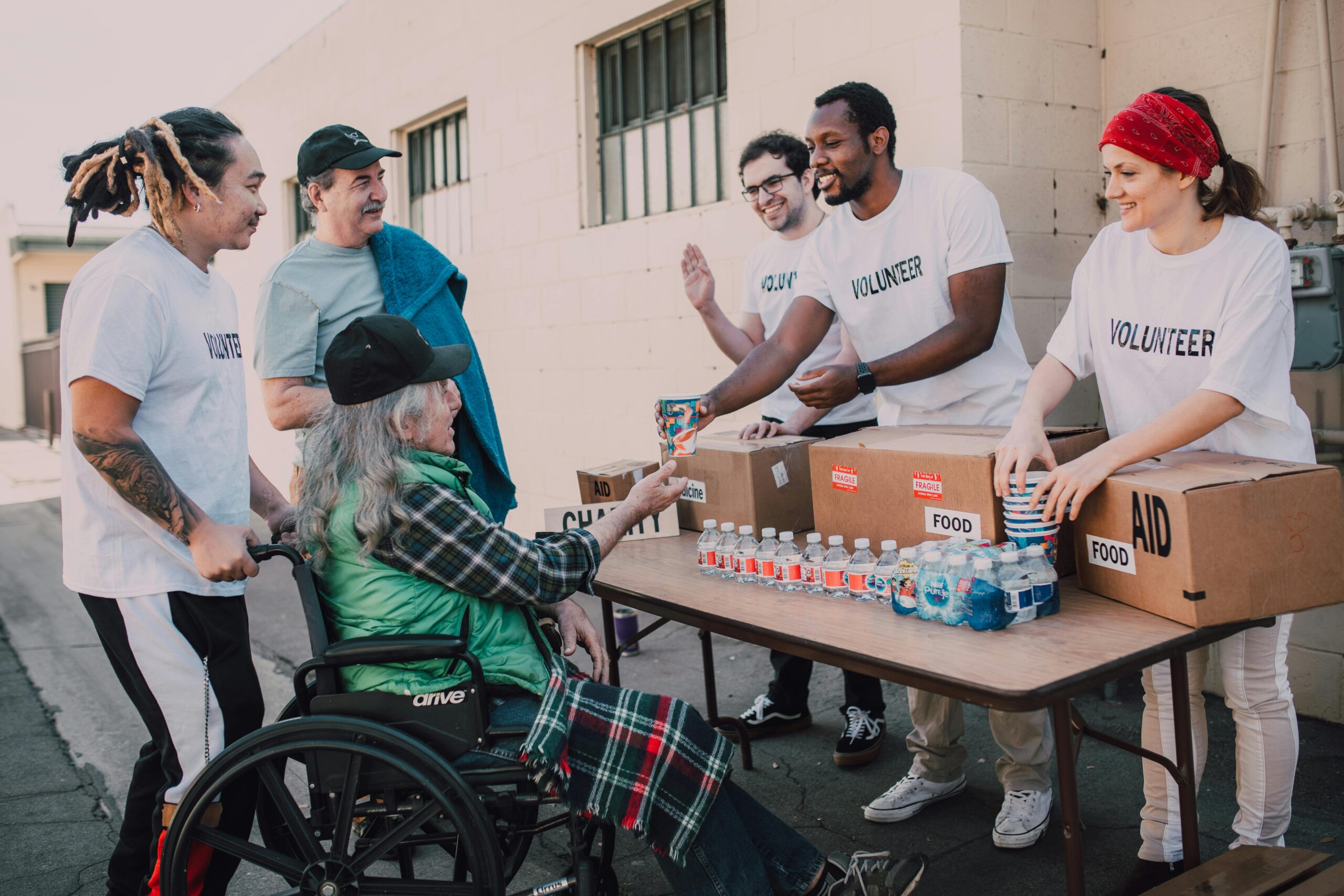 Volunteers giving out drinks to people