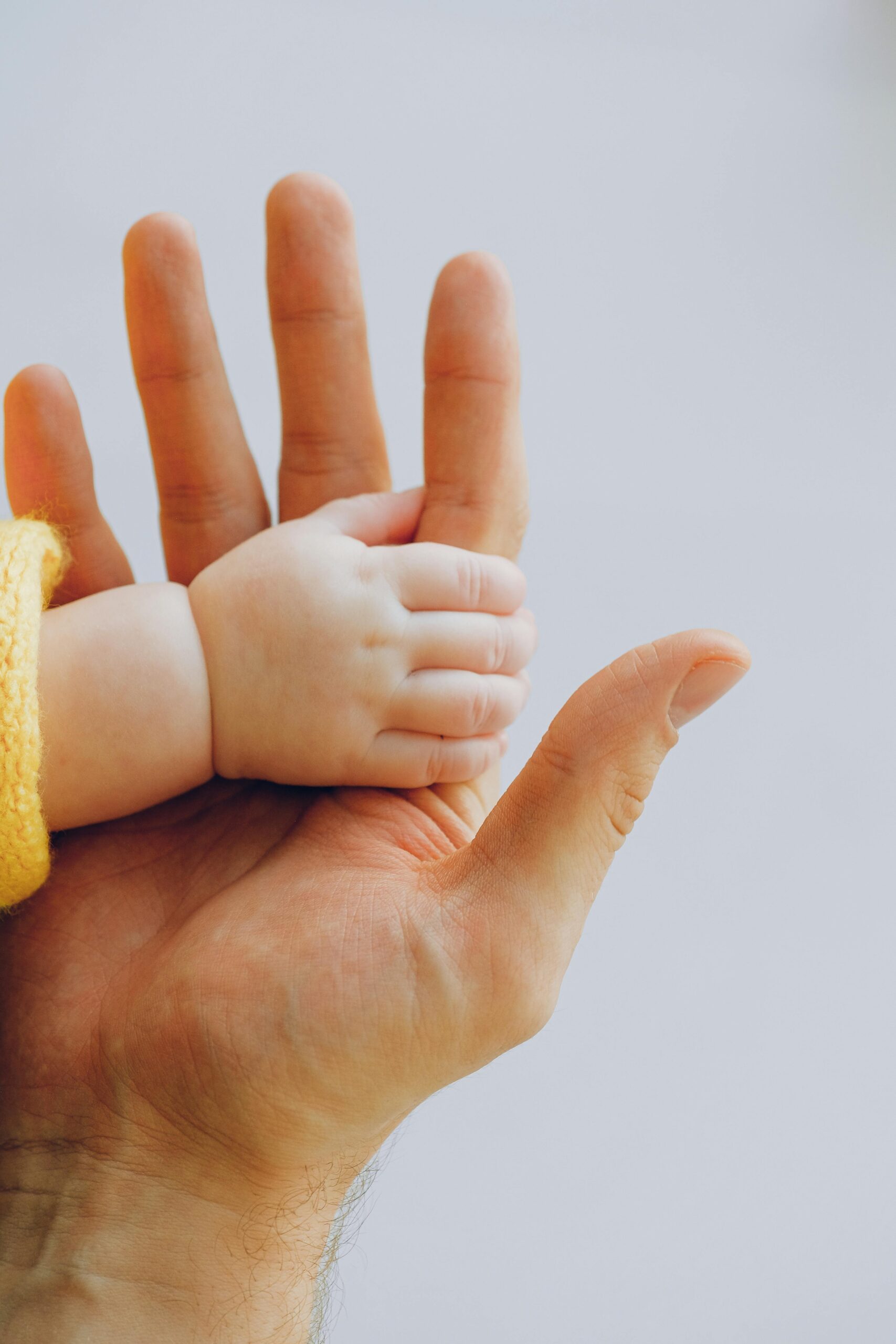 Childs hand holding an adult hand